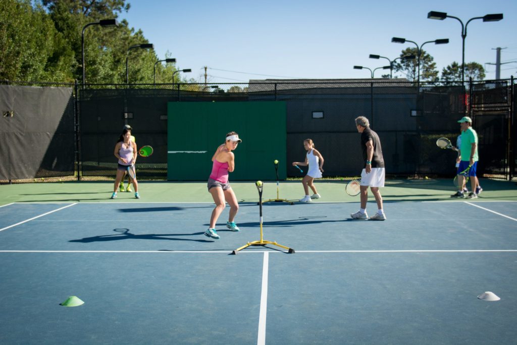 Young players training tennis with Lenny Schloss