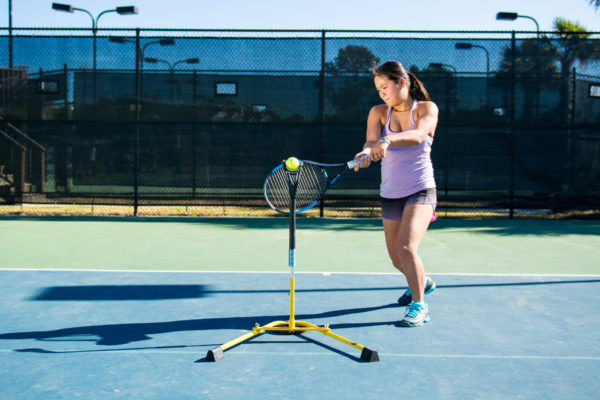 Young woman training tennis using Eye Couch Junior